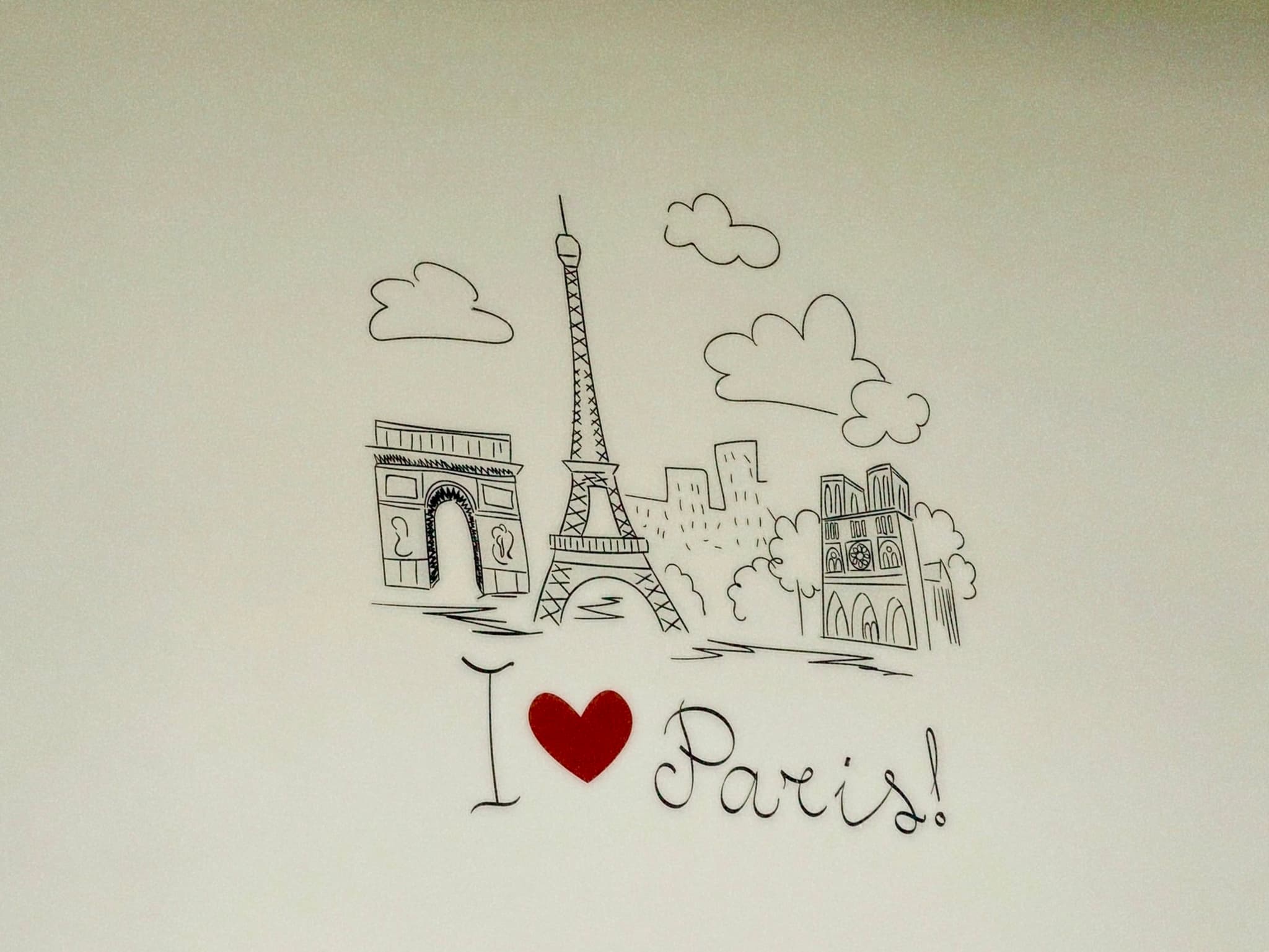 Hand-drawn Paris sketch with Eiffel Tower, Arc de Triomphe, and I ♥ Paris! text, set against a clean white background